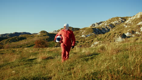 astronaut walks lonely among the desolate lands of the new planet