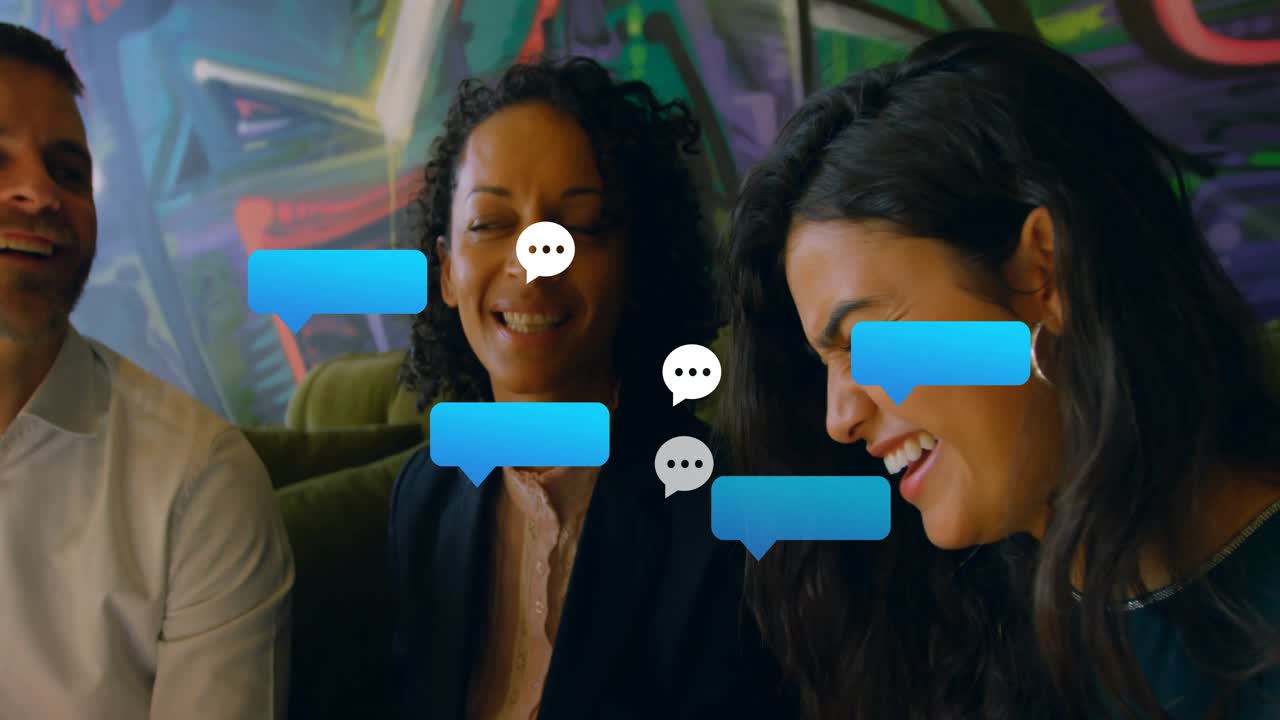 Two women and one man tapping phone on green sofa, watching chat bubbles multiplying for marketing