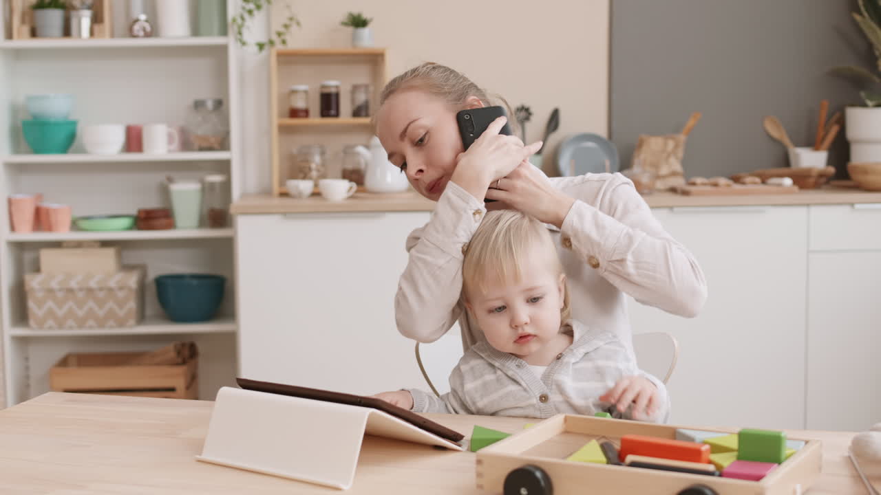 Busy Mom Working and Babysitting Toddler