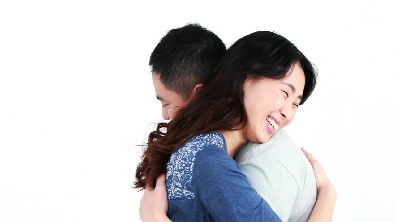 행복 한 커플 이 포옹 하고 카메라 를 쳐다보고 있다