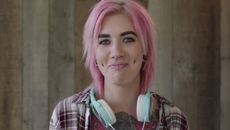 young punk girl portrait of attractive woman with pink hairstyle smiling happy looking at camera wooden background independent urban female body art tattoo