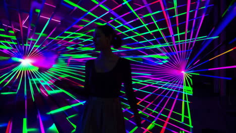woman silhouetted by dynamic laser light show