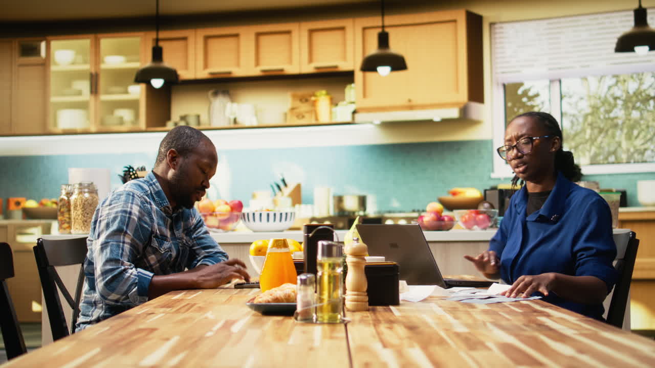 Couple working together at kitchen table