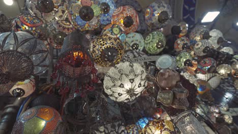 colorful mosaic lamps hanging in a bazaar