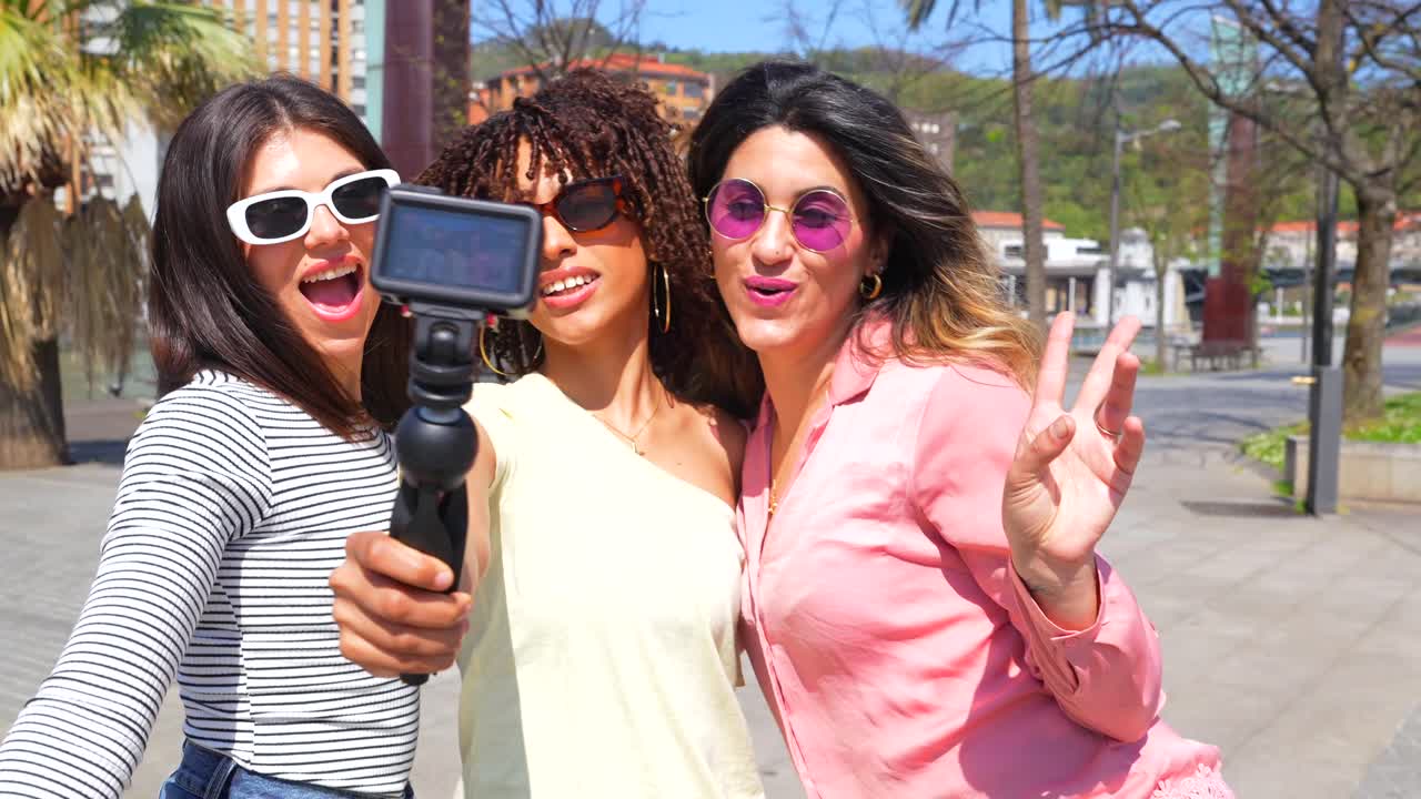 Group of women taking selfies in the city