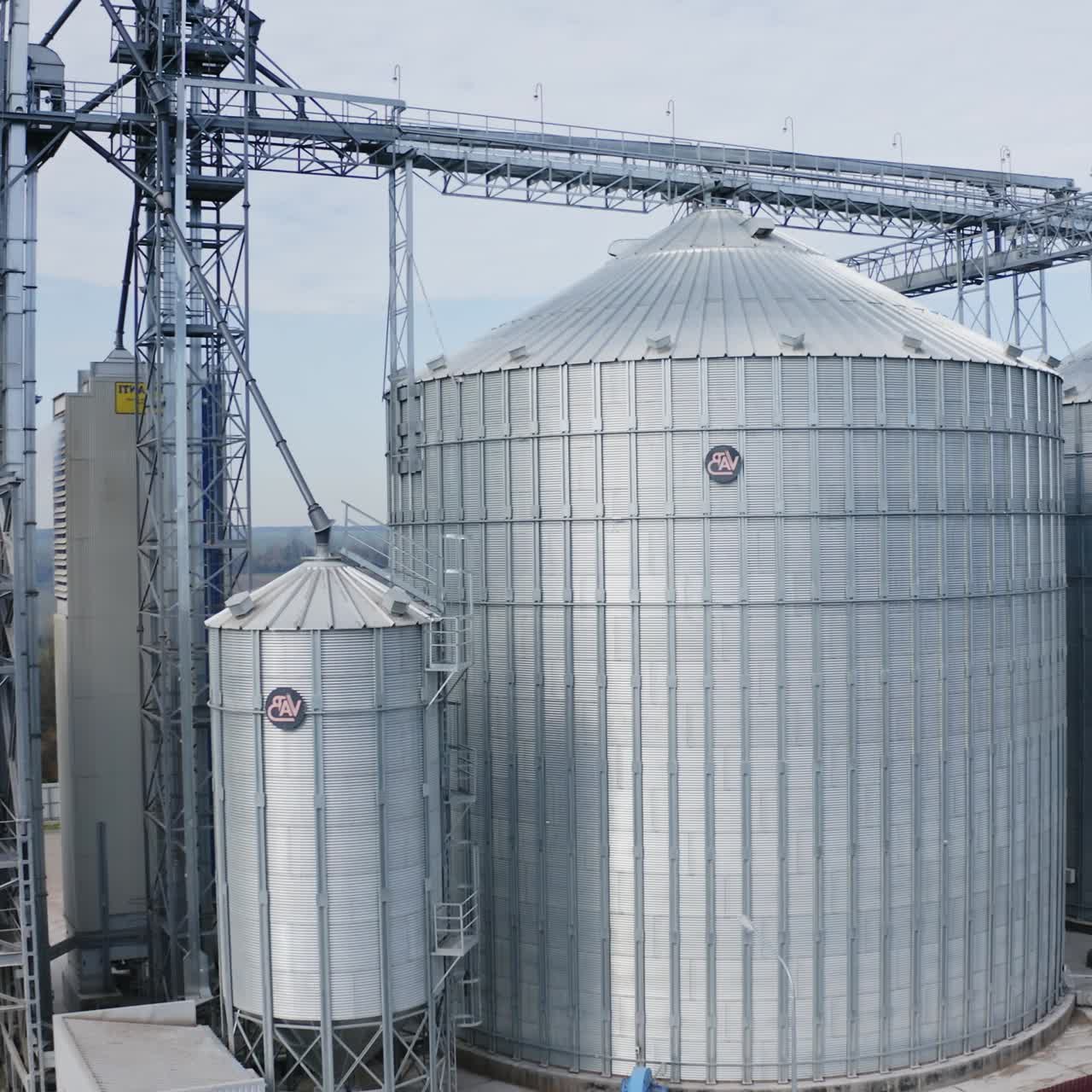 Big industrial steel elevator containers. Farming grain agricultural tanks