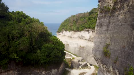aéreo: disparo de drones volando a través de montañas para revelar una hermosa playa