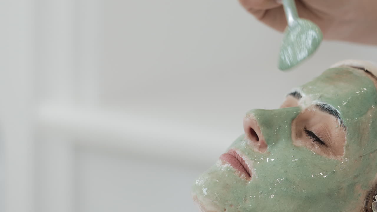 Woman receiving a facial treatment with a face mask
