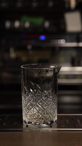 bartender pouring a red cocktail