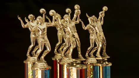 series of volleyball trophies for the champions, rotating on a black background