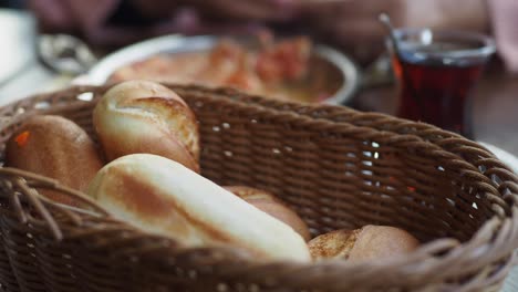 a wicker basket of bread rolls on a table