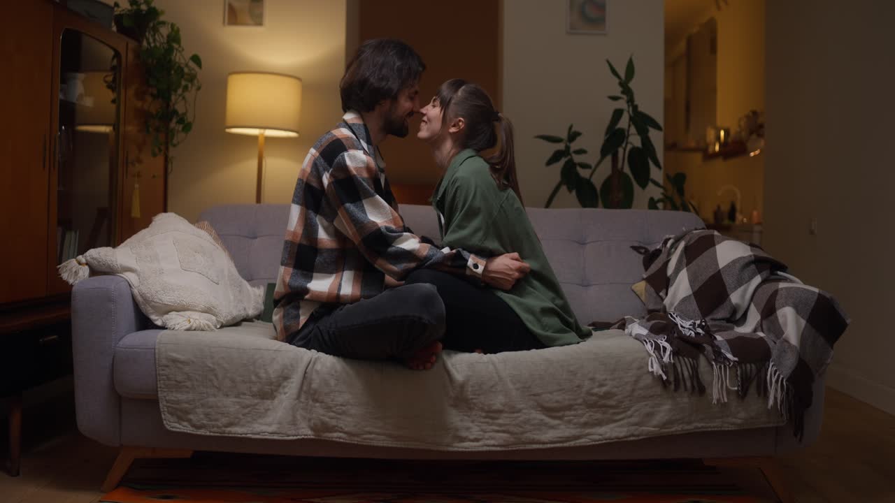 Affectionate Couple Embracing on Couch at Home