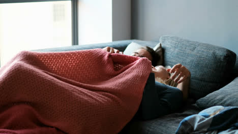 couple lying on sofa at home 4k