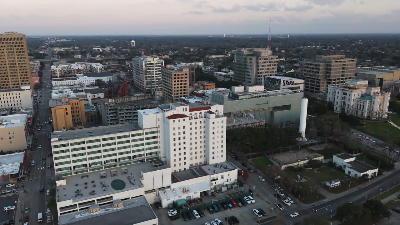 Aerial view rotating in front of the cityscape of Baton Rouge, dusk in Louisiana