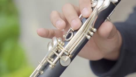 close up view of musician fingers playing clarinet music instrument