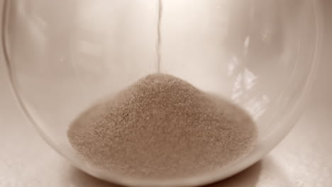 Hourglass-sand-falling-in-slow-motion-close-up