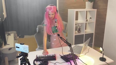 woman singing and recording music in a home studio