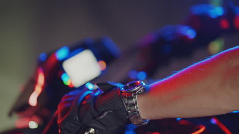 motorcycle rider's hand on handlebar at night