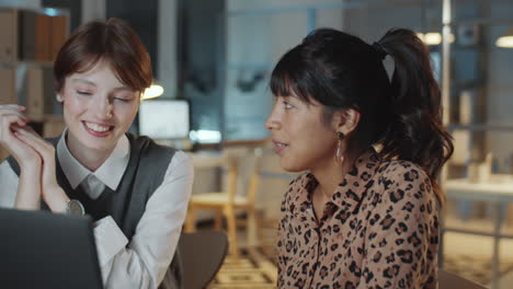 two young multiethnic businesswomen working late in office