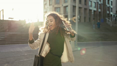 Woman,-happy-and-dancing-to-music-in-city-morning