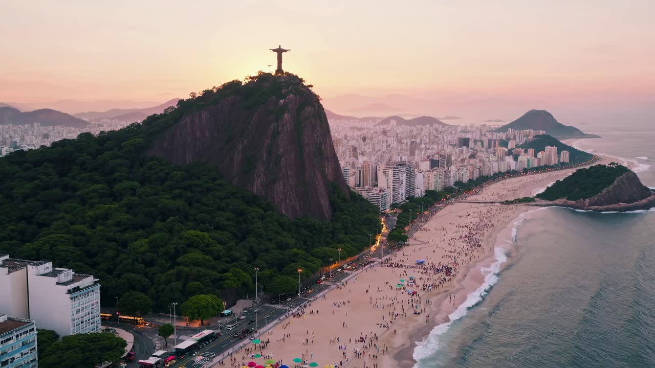 Aerial video view of Rio's coastline at sunset, capturing Christ the Redeemer atop Corcovado