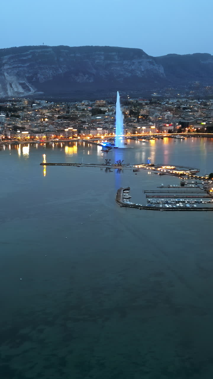Aerial, drone view of the Geneva Water Fountain in Switzerland in the evening. Vertical