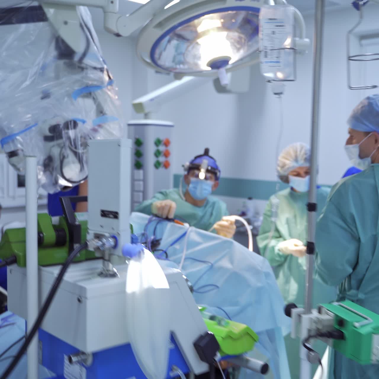 Entering the up-to-date operational room. Team of professional surgeons performing operation. Well-equipped surgery room in clinic