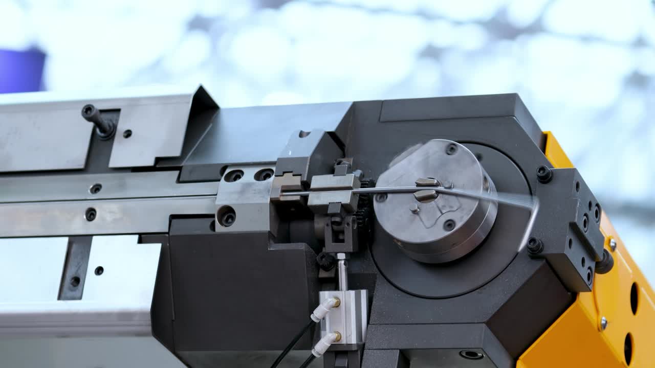 Wire bending machine. CNC metal processing. Automated metalworking machine.