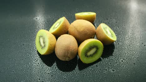 whole and cut kiwifruit on table