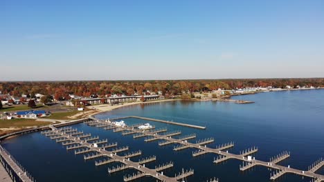 a high angle flyover of harbor park marina on lake huron in the autumn season