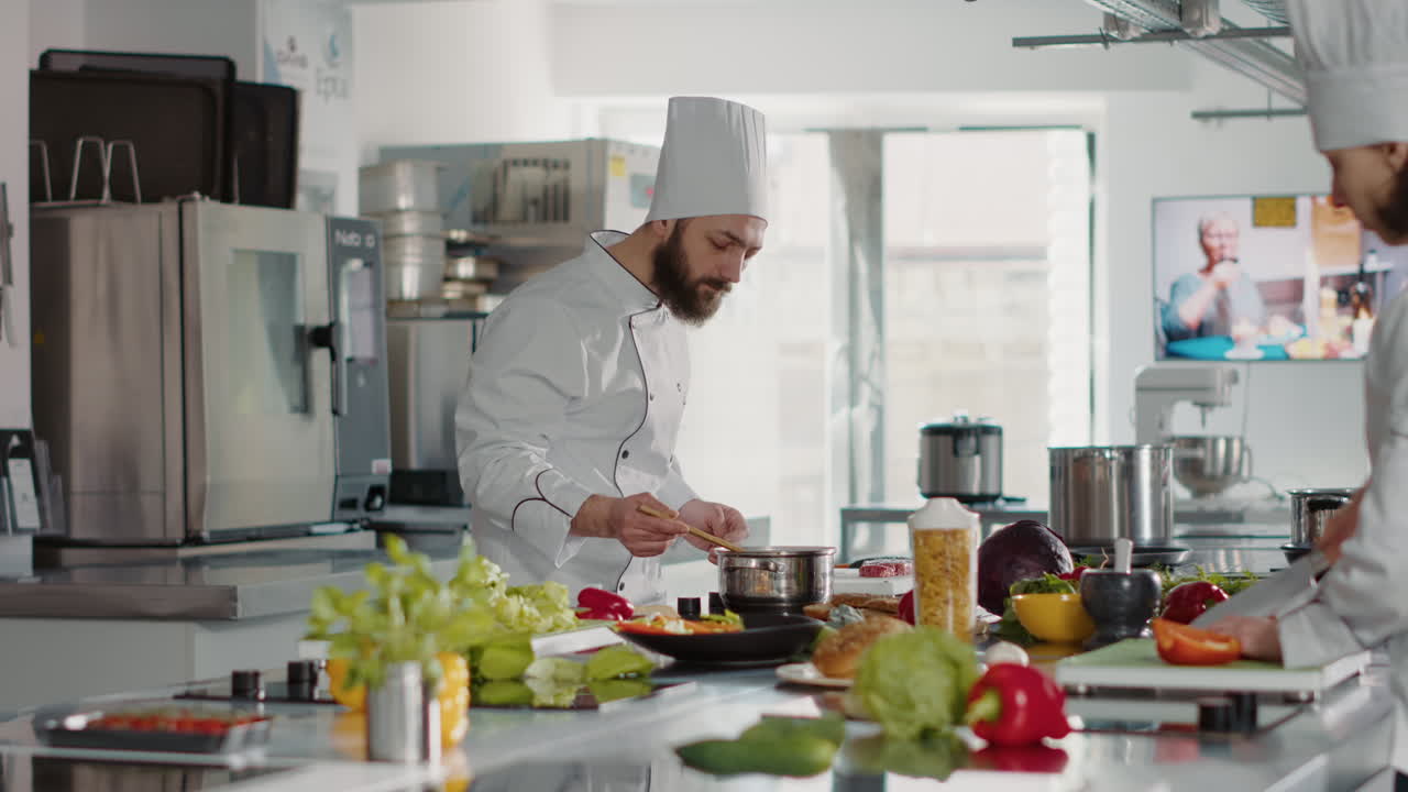 Professional chef testing soup taste in pot on stove