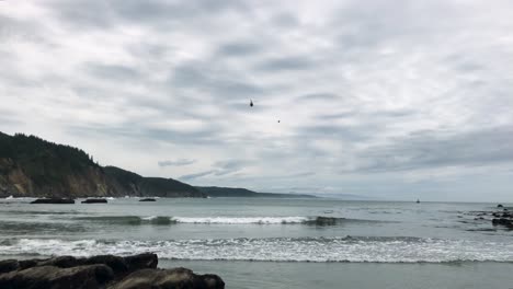 Coast-guard-helicopter-approaches-south-cove-beach-for-landing-on-the-Oregon-Coast-near-Sunset-Bay-state-park-and-Shore-Acres-State-park