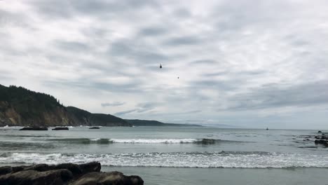 coast guard helicopter approaches south cove beach for landing on the oregon coast near sunset bay state park and shore acres state park