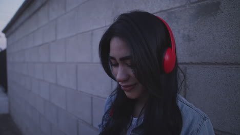 Young-man-listening-music-and-smiling-as-provocative-way