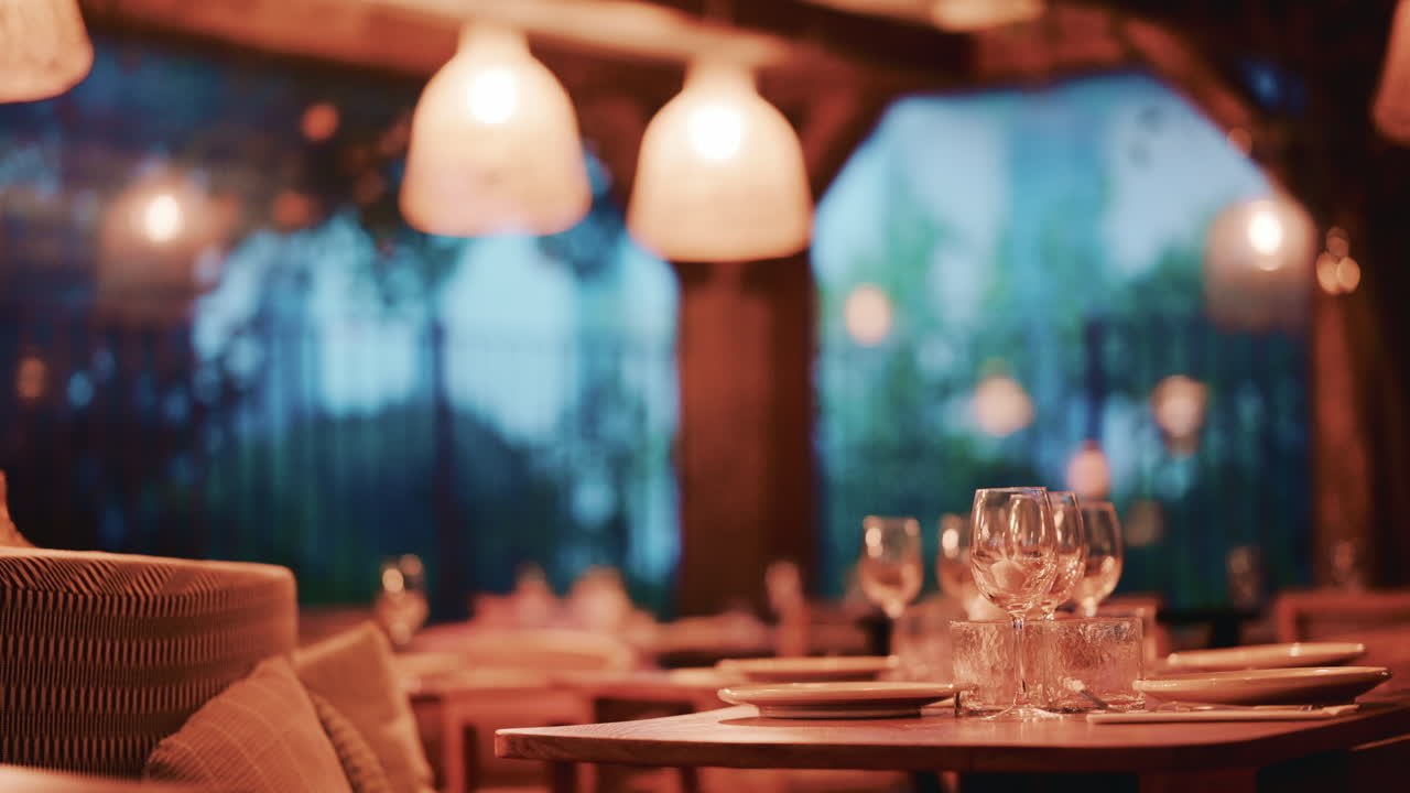 Woman with long wavy hair, viewed from behind as she looks at pastries through the display glass