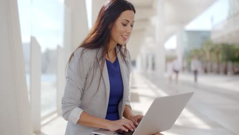 Businesswoman-relaxing-and-working-on-a-laptop