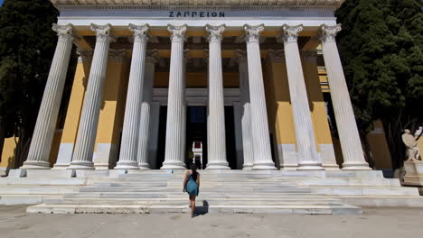 Slow-motion-follow-shot-of-female-tourist-entering-Zappeion-Hall-in-Greece