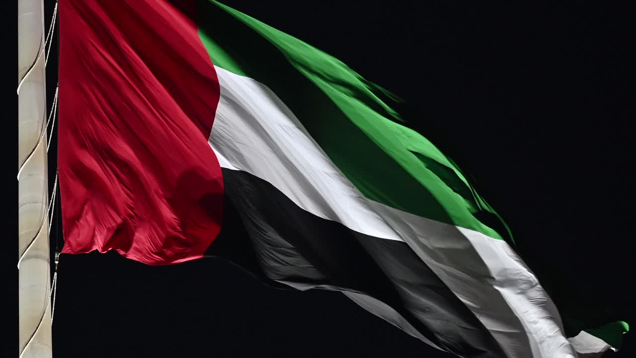 Closeup: Night view of the Flag of UAE, The national symbol of the United Arab Emirates