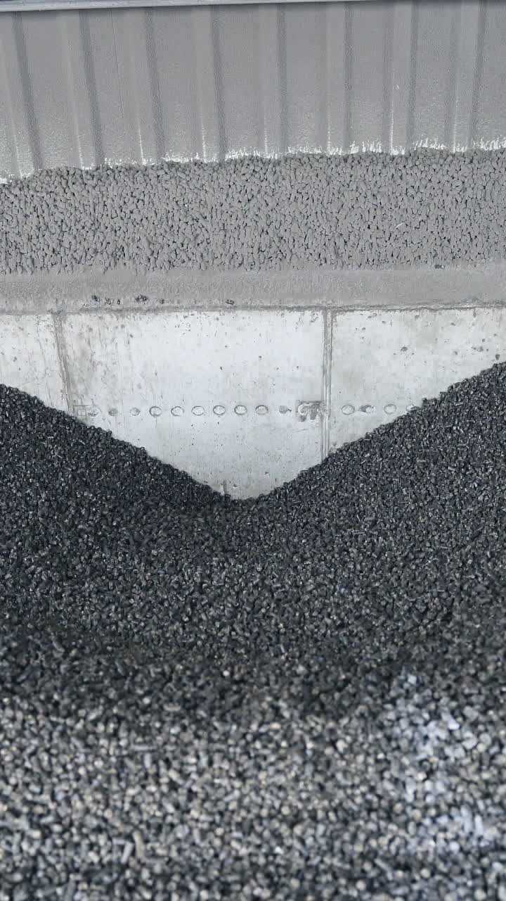 Automatic pellet burner system. Automatic pellet burner system, loading pilots into the oven. Vertical video