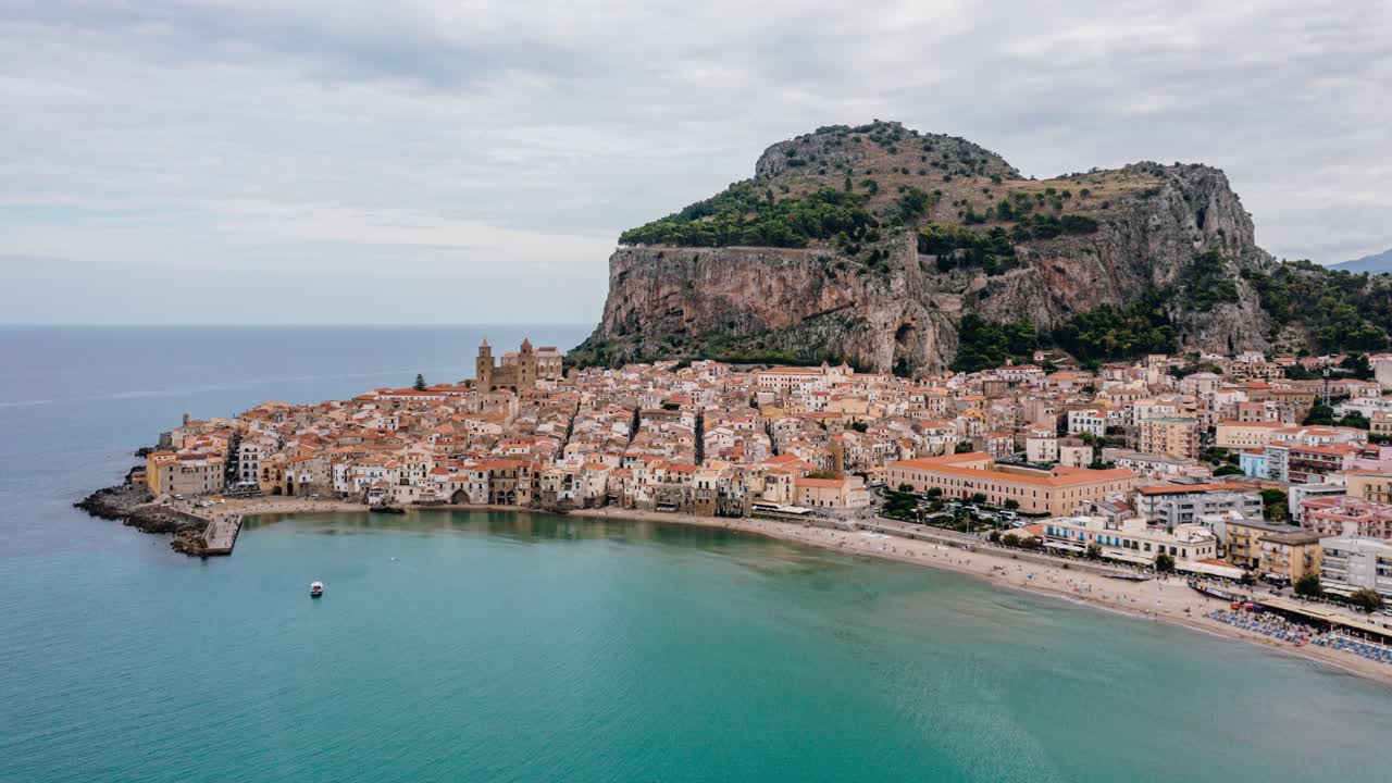 Drone Hyperlapse of Cefalu. Ancient Italian town along the Mediterranean sea coast of Sicily island.
