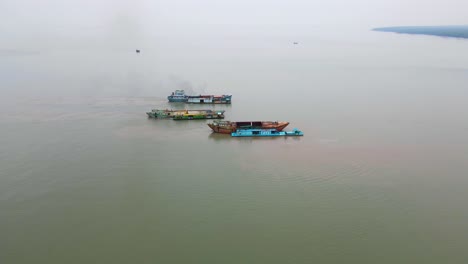 cargo ships moored in dirty sea waters for sand dredging of bengal bay