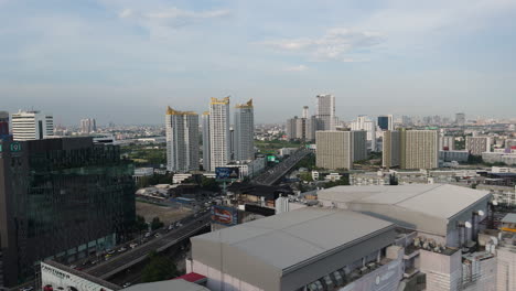traffic at sirat expressway with tc-green condominium in huai khwang, bangkok, thailand. - aerial shot