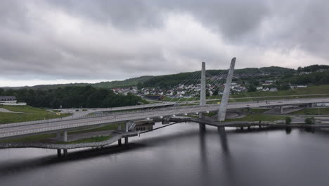 dramatic cloudy sky at farris bridge over the lake on the town of larvik in norway