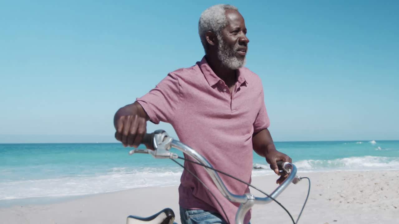 Senior man with a bike at the beach