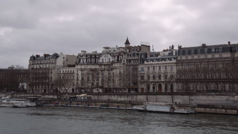historic architectural buildings at the bank of seine river, paris, france