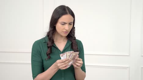 Confused-Indian-woman-counting-money