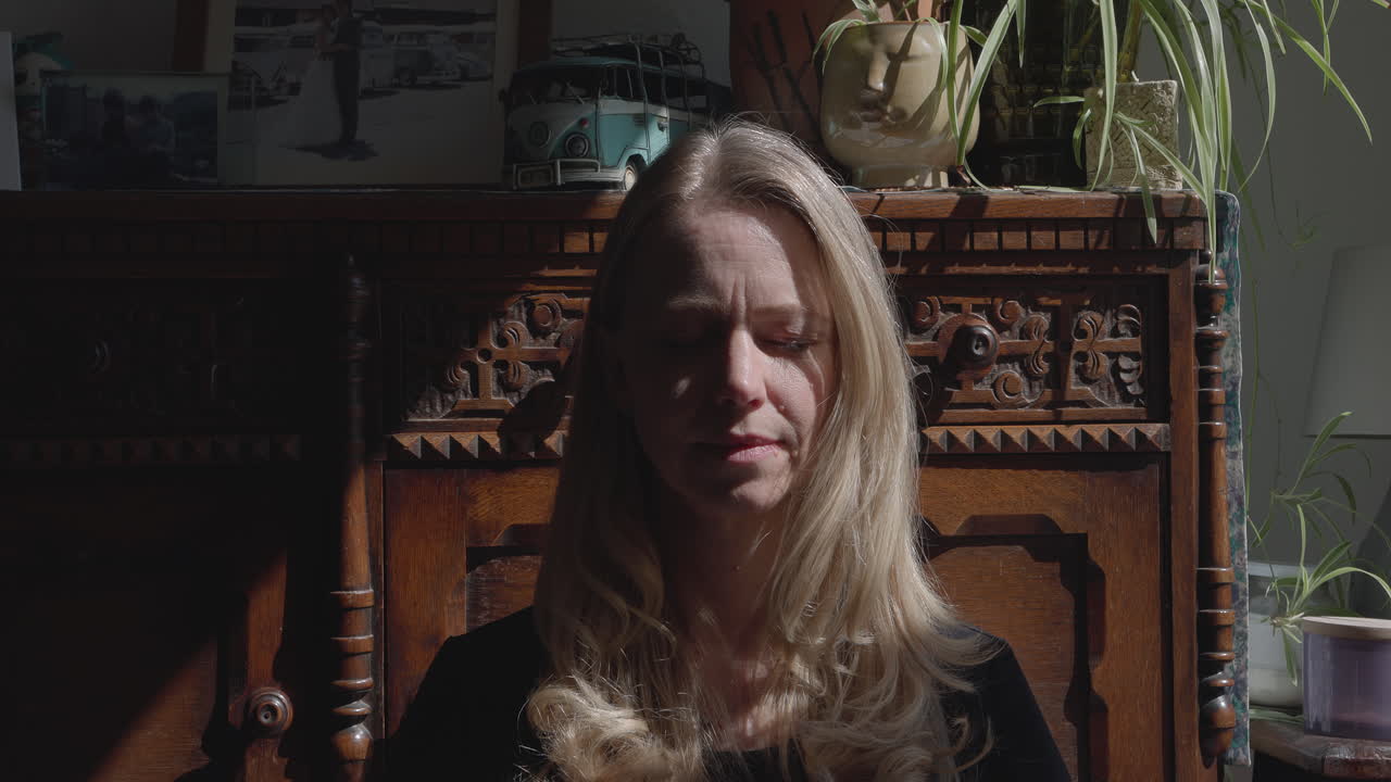 A woman in front of a wooden cabinet