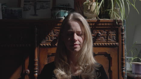 a woman in front of a wooden cabinet