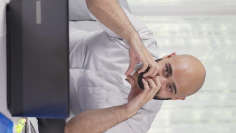 Vertical-video-of-Home-office-worker-man-makes-heart-symbol-looking-at-camera.