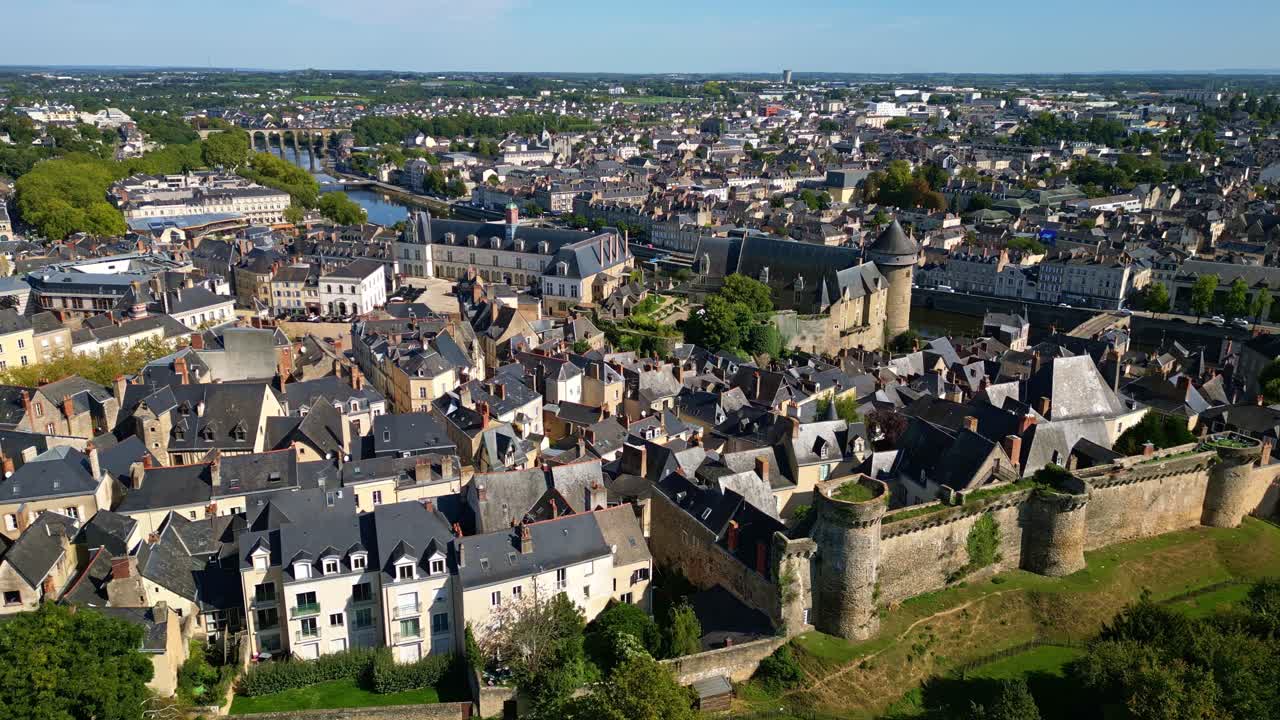 Drone tracking right of southern ramparts with Chateau Laval and Chateau Neuf visible in daylight, establishing